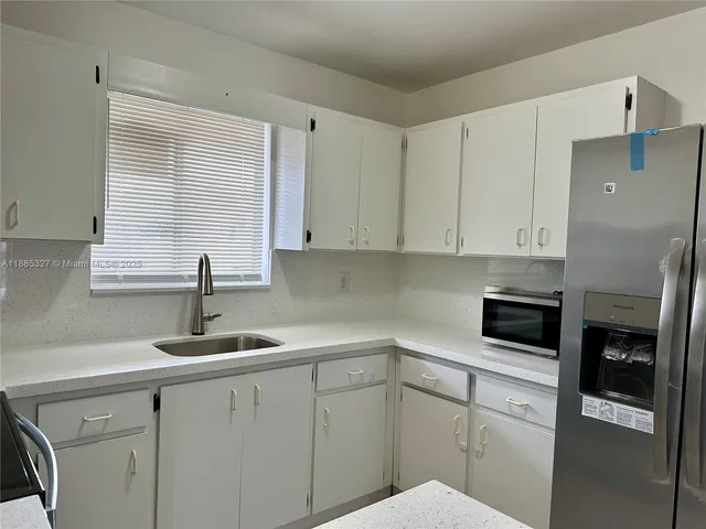 a kitchen with a sink and cabinets