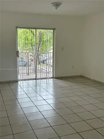 a view of an empty room and a window