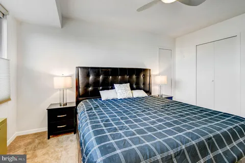 a bedroom with a bed and a night stand