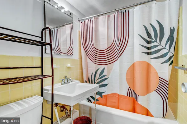 a bathroom with a sink a mirror and a bathtub