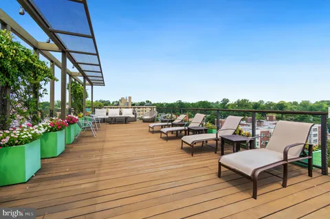 a terrace with outdoor seating and city view