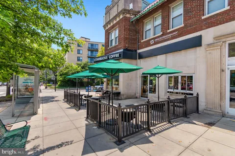 a view of a patio with a table and chairs under an umbrella