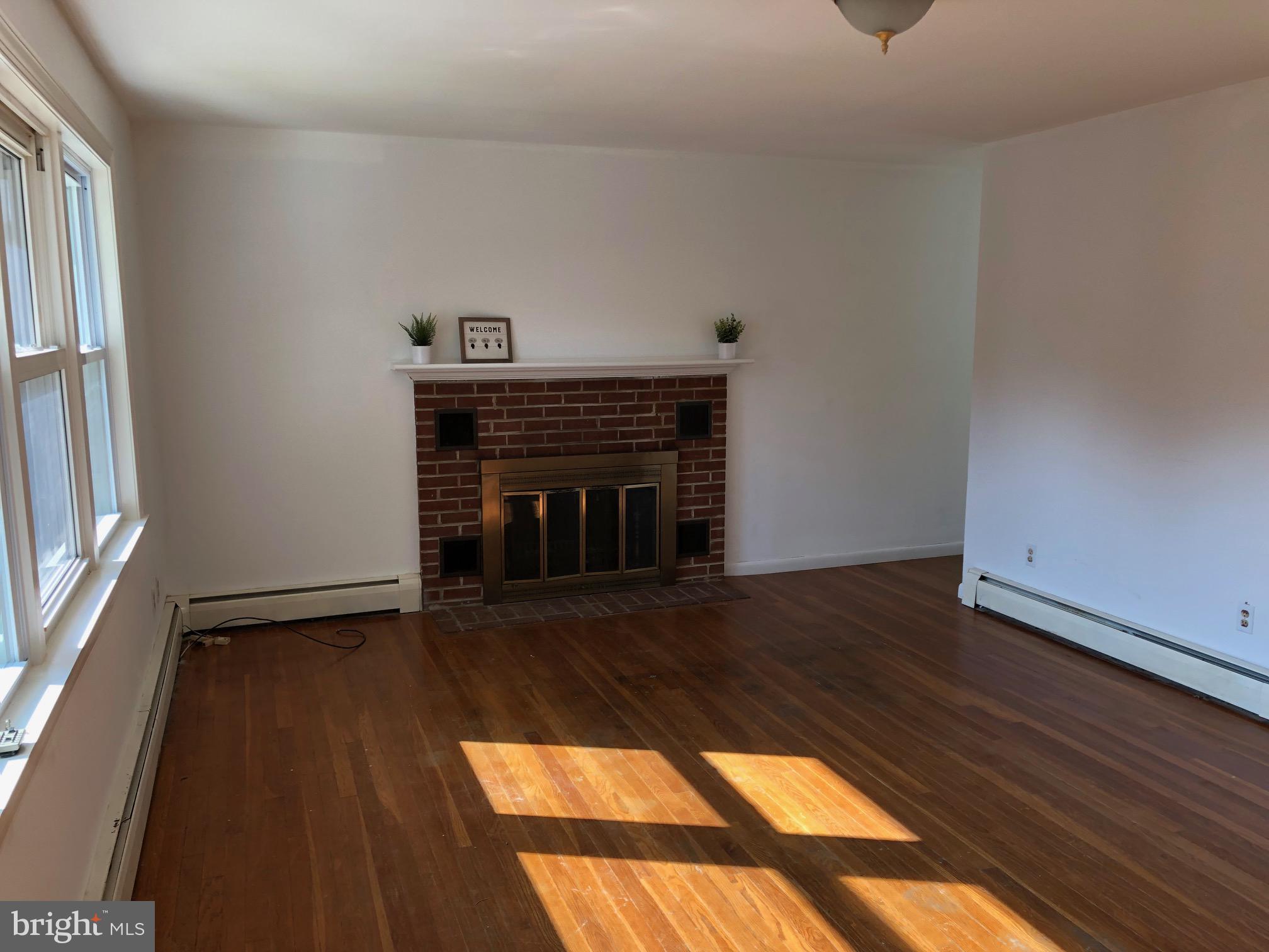 107 Cedar Road Wallingford, PA 19086 - Photo 4 of 30 Sunny Living room with fireplace