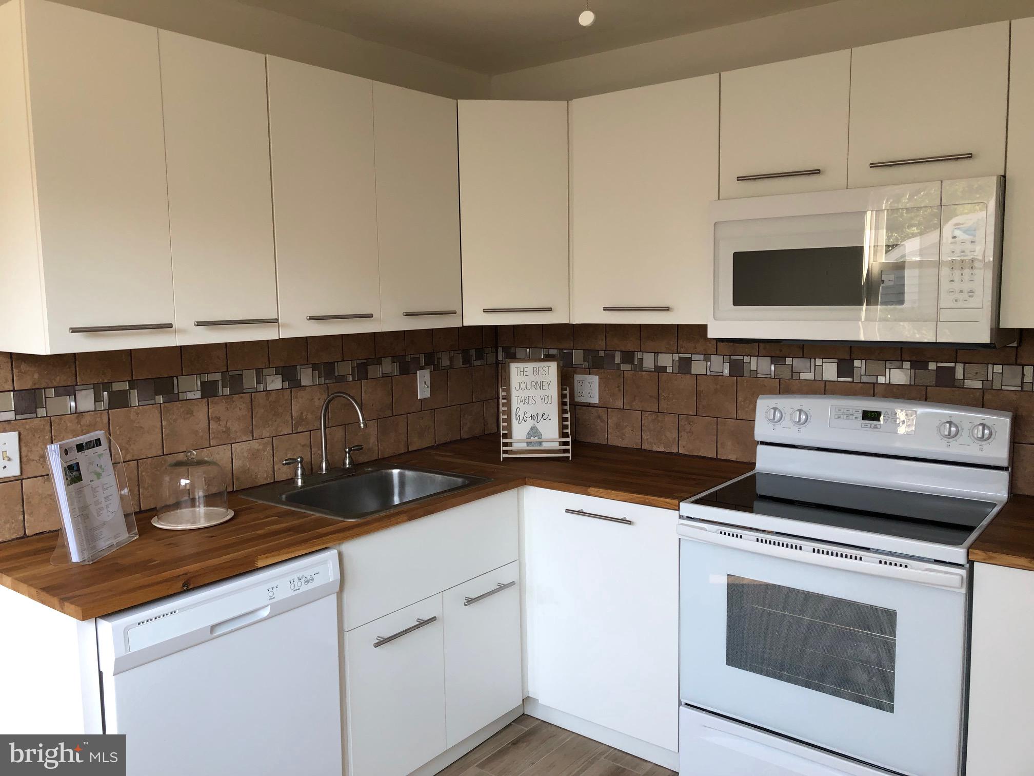 107 Cedar Road Wallingford, PA 19086 - Photo 6 of 30 Remodeled Kitchen with ceramic tile backsplash