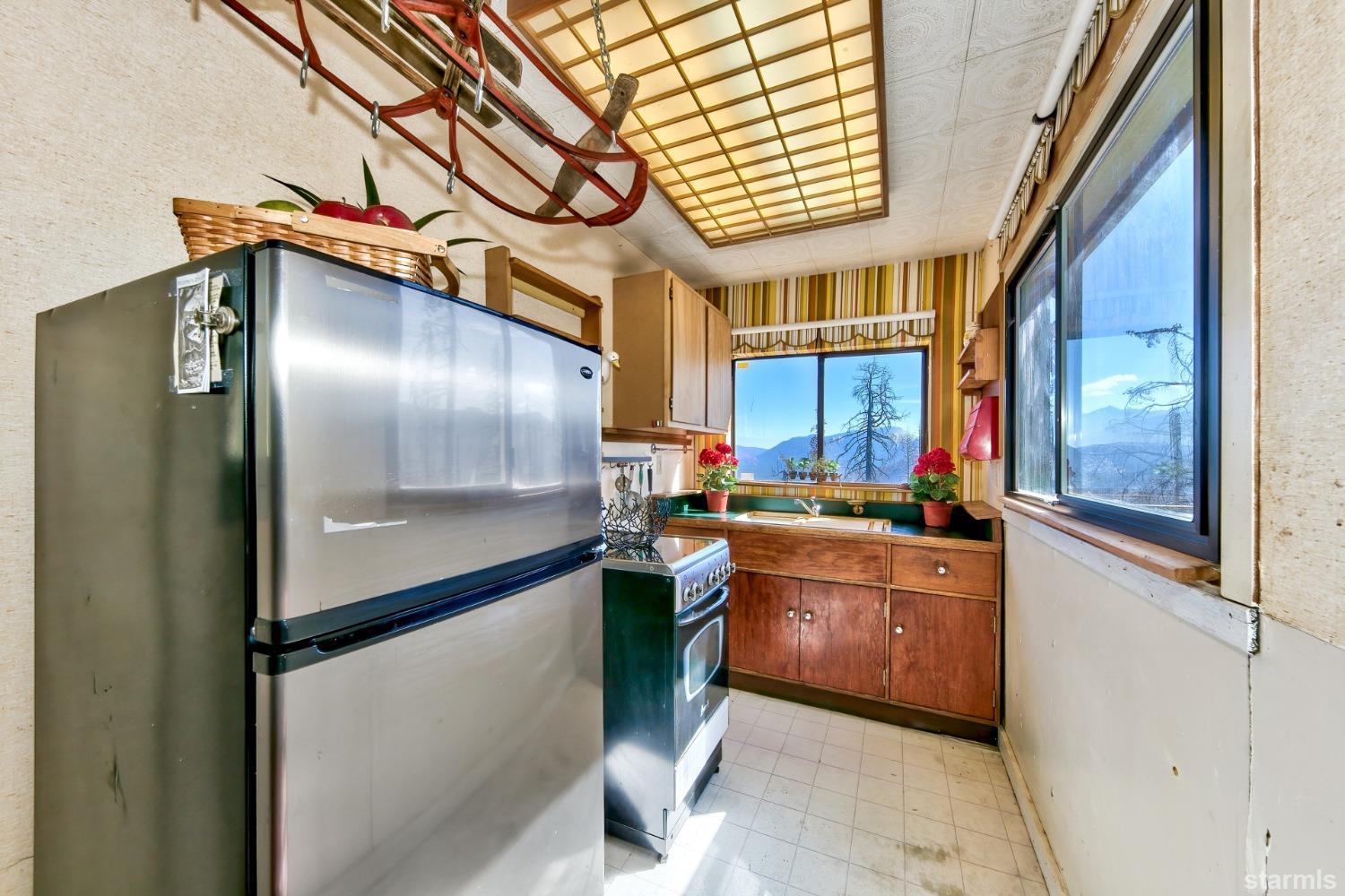 8611 Echo Road Echo Lake, CA 95721 - Photo 12 of 19 a kitchen with stainless steel appliances granite countertop a refrigerator a sink a stove and wooden floors
