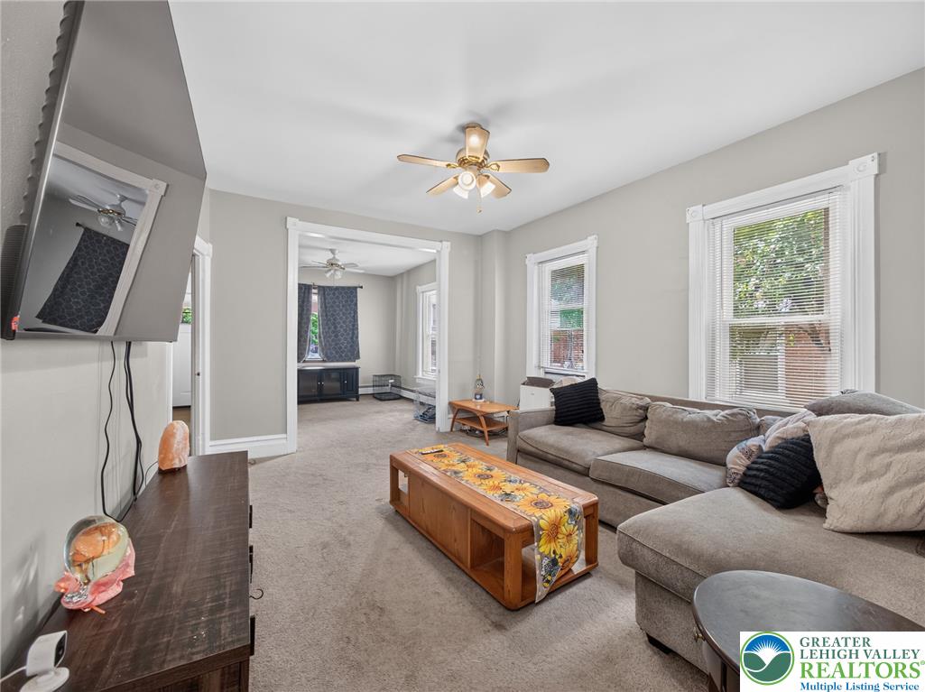 425 Ridge Street Emmaus, PA 18049 - Photo 10 of 27 A comfortable living space featuring soft gray walls and inviting natural light.