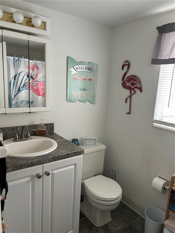 1524 Pleasant Road, Unit G24 Bradenton, FL 34207 - Photo 12 of 18 a bathroom with a granite countertop toilet sink and mirror