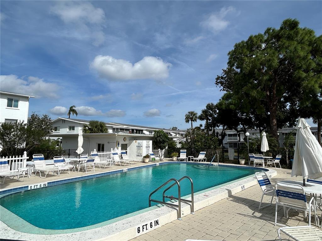 1524 Pleasant Road, Unit G24 Bradenton, FL 34207 - Photo 17 of 18 a view of a house with swimming pool and sitting area