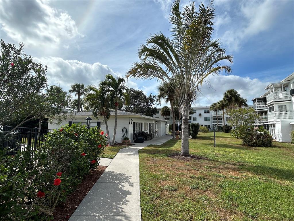 1524 Pleasant Road, Unit G24 Bradenton, FL 34207 - Photo 2 of 18 a house with palm tree in front of it