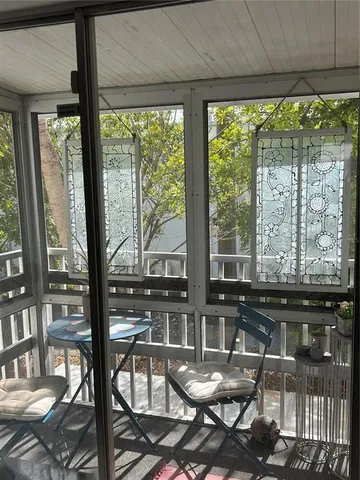 a view of a dining room with furniture and floor to ceiling window