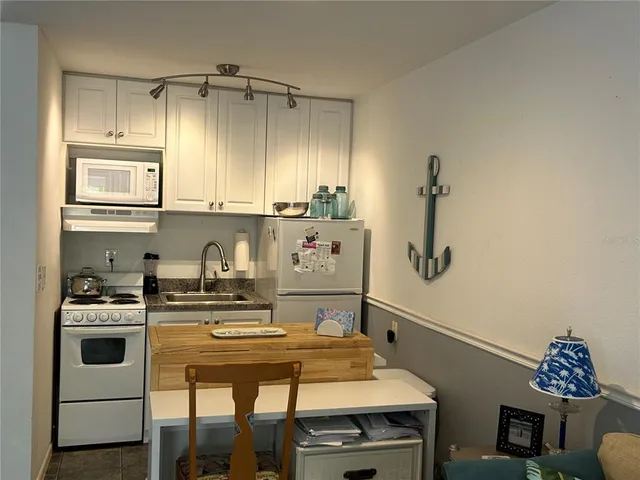 a kitchen with a stove a sink and a microwave