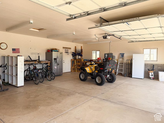425 East Mule Deer Road Central, UT 84722 - Photo 53 of 72 Garage with stainless steel fridge and a garage door opener