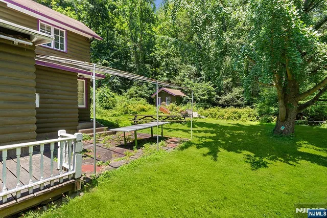 a view of backyard with two chairs and a table