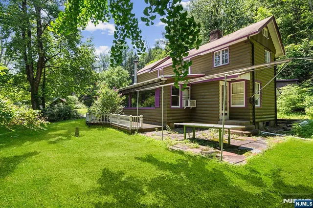 a view of a house with backyard and sitting area