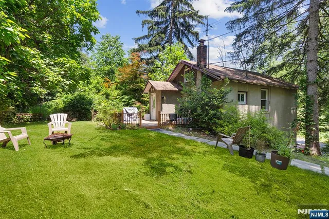 a house view with a sitting space and garden