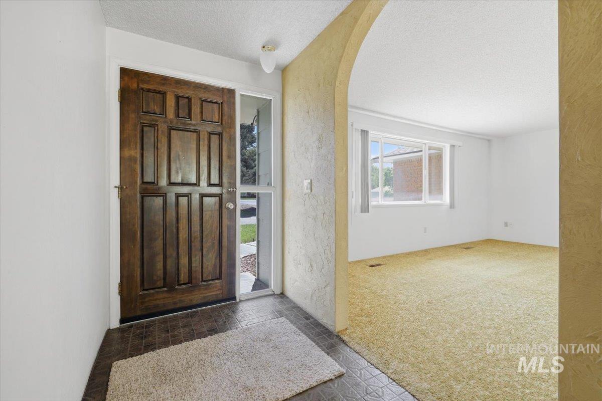 1311 North Middleton Road Nampa, ID 83651 - Photo 17 of 49 Wood-paneled entry door with sidelight and transom window