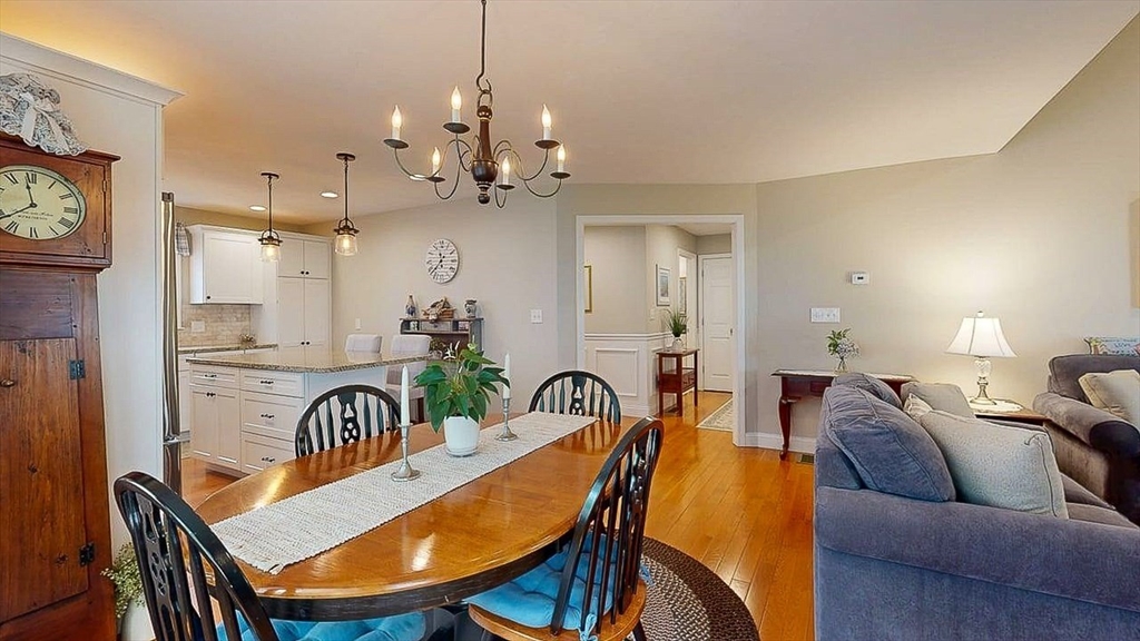 67 Cobblestone Lane, Unit 63 Worcester, MA 01606 - Photo 12 of 38 a view of a dining room with furniture and a chandelier