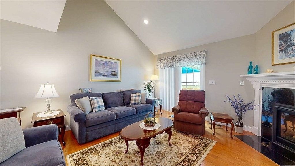 67 Cobblestone Lane, Unit 63 Worcester, MA 01606 - Photo 13 of 38 a living room with furniture and a fireplace