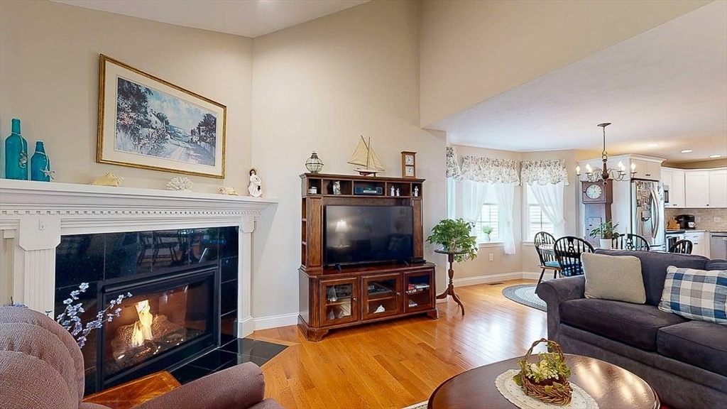 67 Cobblestone Lane, Unit 63 Worcester, MA 01606 - Photo 15 of 38 a living room with furniture a flat screen tv and a fireplace