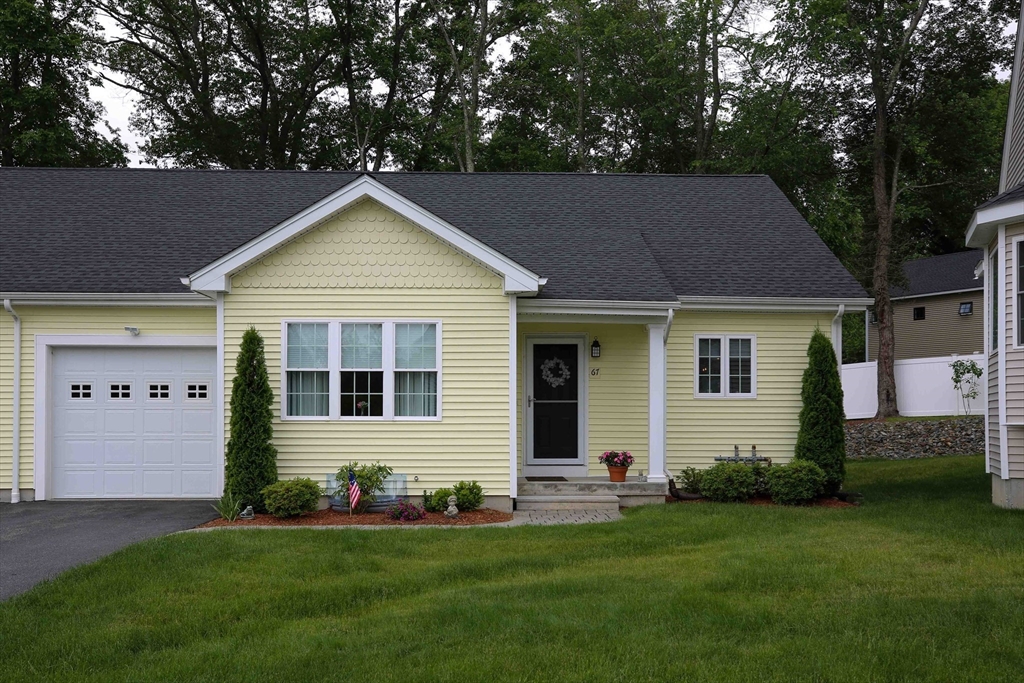 67 Cobblestone Lane, Unit 63 Worcester, MA 01606 - Photo 2 of 38 a front view of a house with a yard