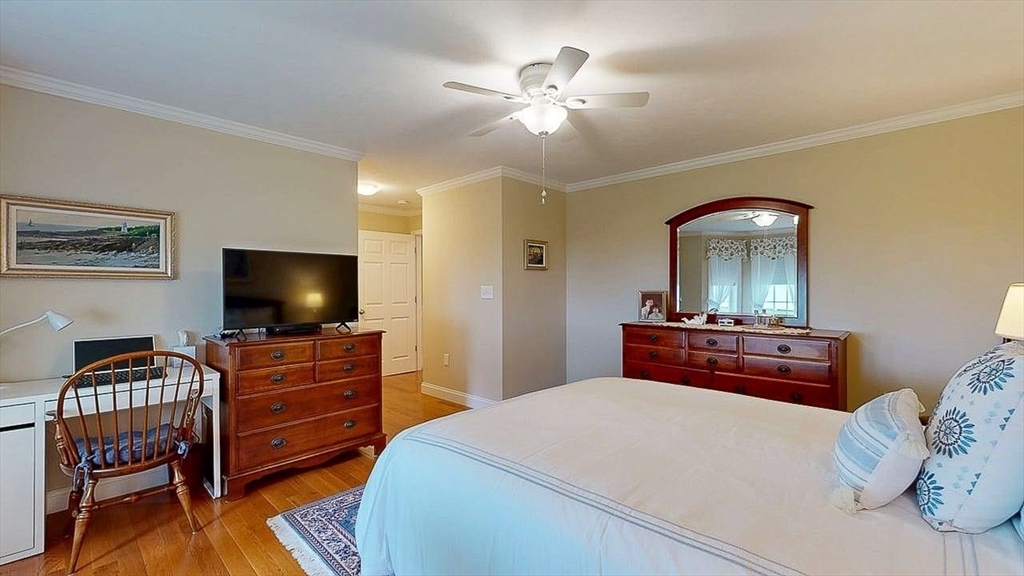 67 Cobblestone Lane, Unit 63 Worcester, MA 01606 - Photo 24 of 38 a bedroom with a bed and a flat screen tv