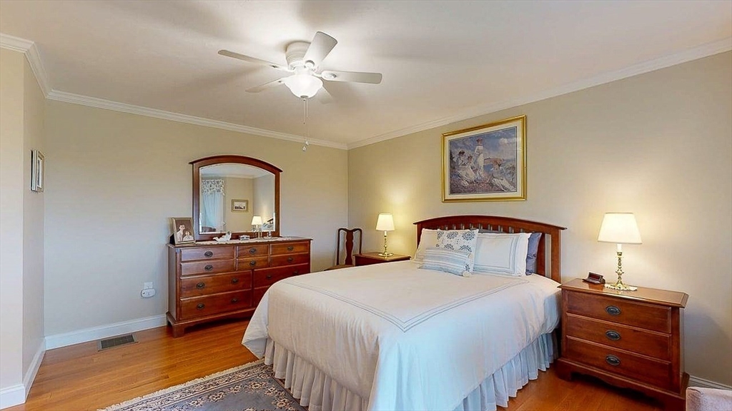 67 Cobblestone Lane, Unit 63 Worcester, MA 01606 - Photo 25 of 38 a bedroom with a bed and a chandelier