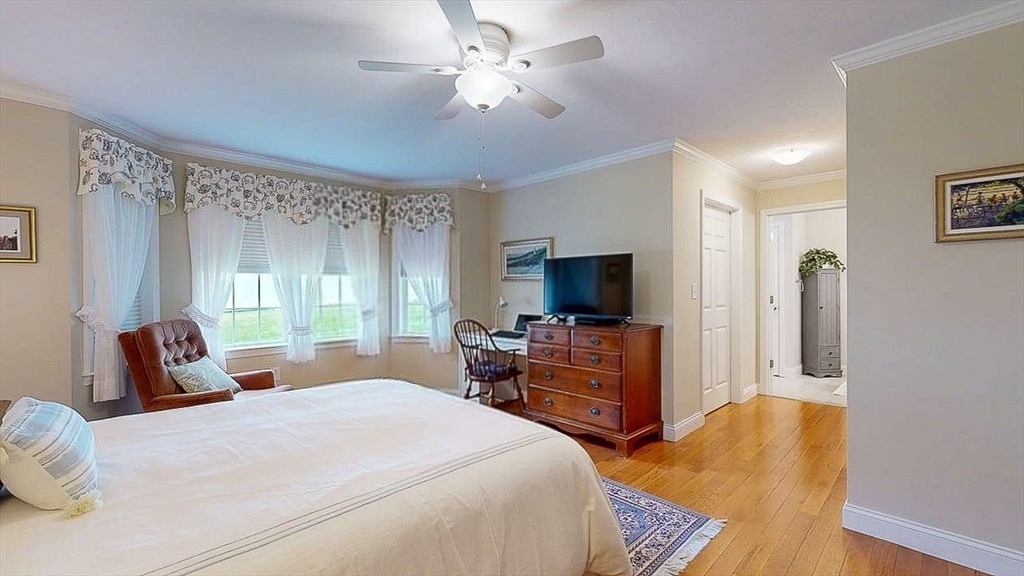 67 Cobblestone Lane, Unit 63 Worcester, MA 01606 - Photo 26 of 38 a bedroom with a bed and a flat screen tv