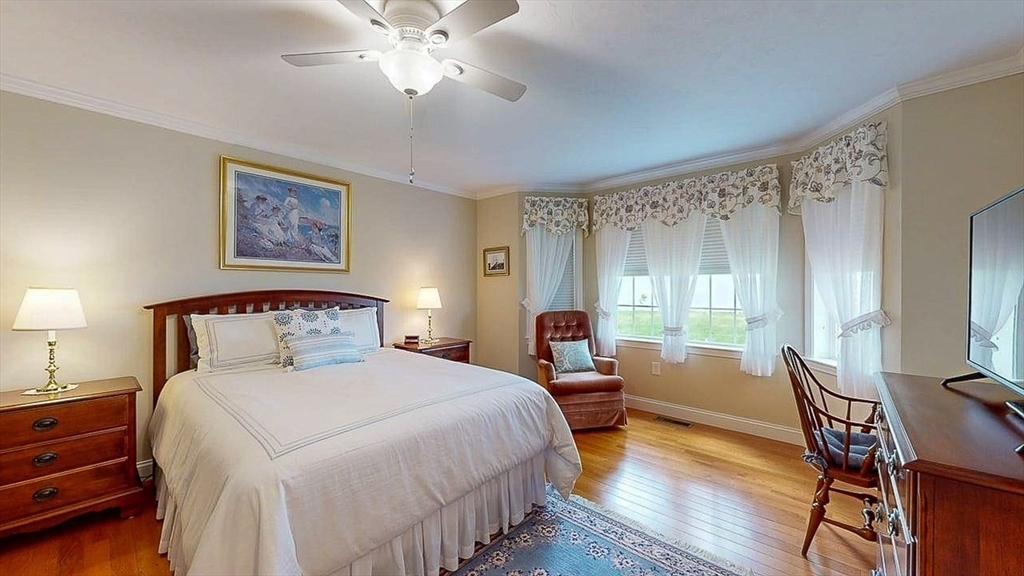 67 Cobblestone Lane, Unit 63 Worcester, MA 01606 - Photo 27 of 38 a bedroom with a bed and a chandelier