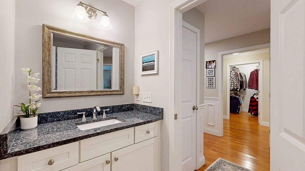 67 Cobblestone Lane, Unit 63 Worcester, MA 01606 - Photo 29 of 38 a bathroom with a granite countertop sink and a mirror