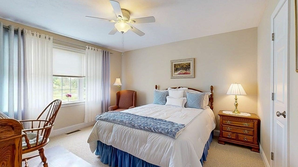 67 Cobblestone Lane, Unit 63 Worcester, MA 01606 - Photo 31 of 38 a bedroom with a bed chairs and a window