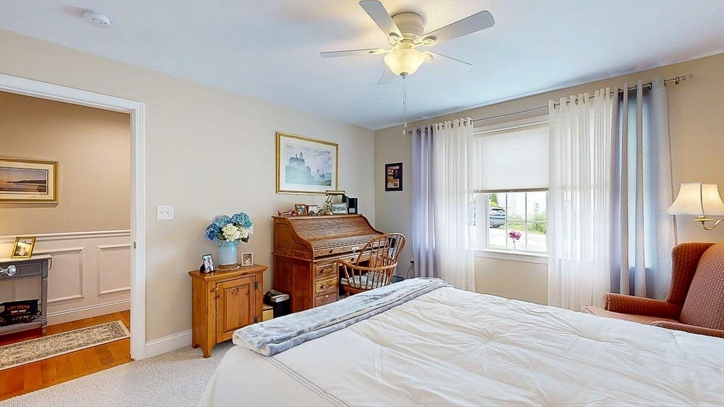 67 Cobblestone Lane, Unit 63 Worcester, MA 01606 - Photo 32 of 38 a bedroom with a bed and wooden floor