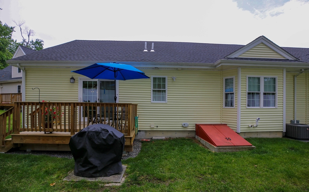 67 Cobblestone Lane, Unit 63 Worcester, MA 01606 - Photo 35 of 38 a front view of a house with a yard and a fire pit