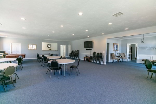 67 Cobblestone Lane, Unit 63 Worcester, MA 01606 - Photo 37 of 38 a living room with furniture and a dining table with chairs