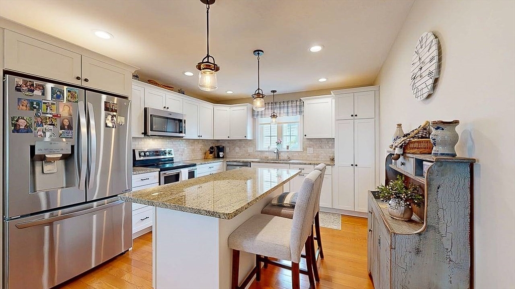 67 Cobblestone Lane, Unit 63 Worcester, MA 01606 - Photo 7 of 38 a kitchen with refrigerator and window