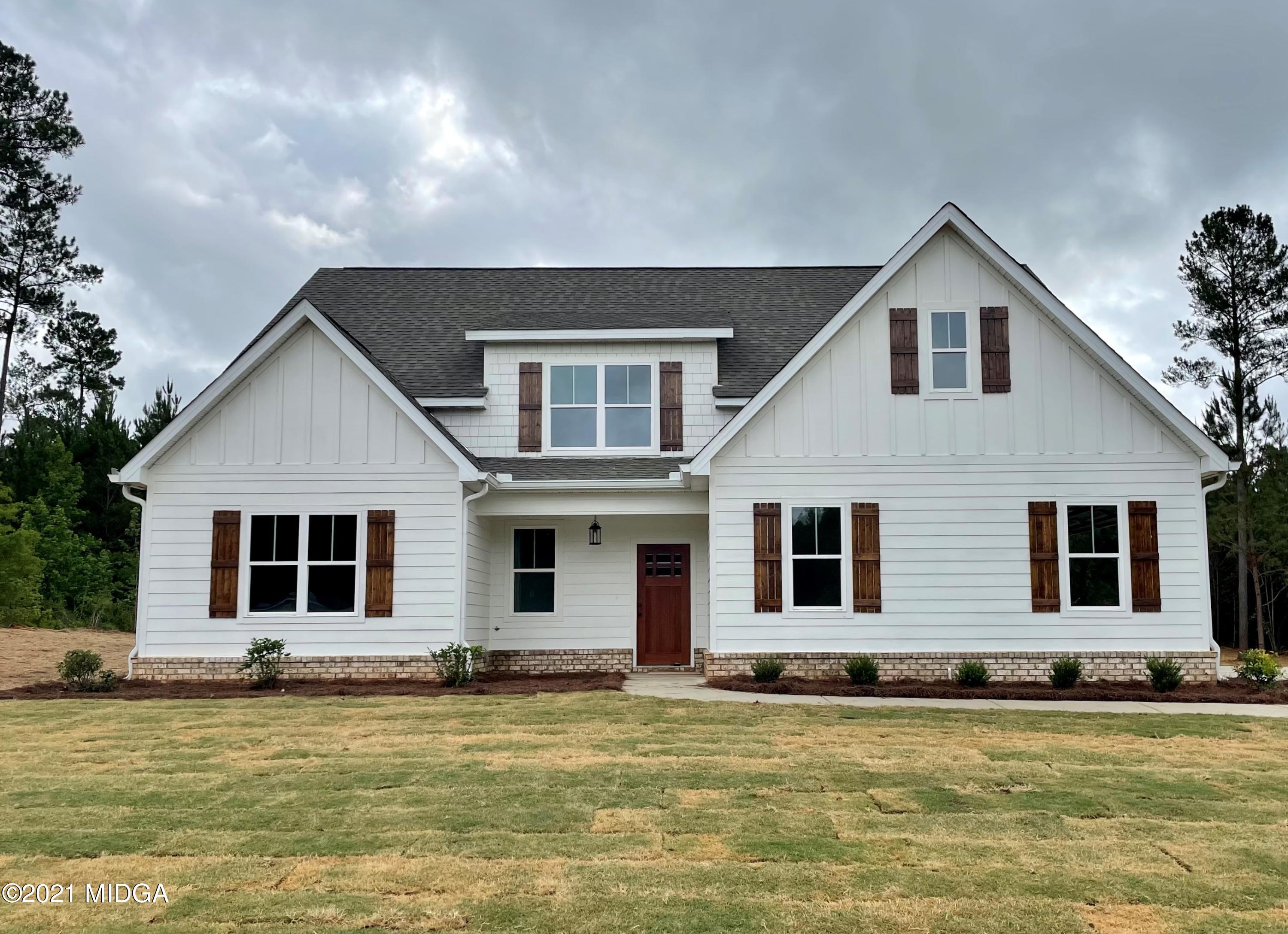 1194 Josey Road Forsyth, GA 31029 - Photo 1 of 9 a front view of a house with a yard