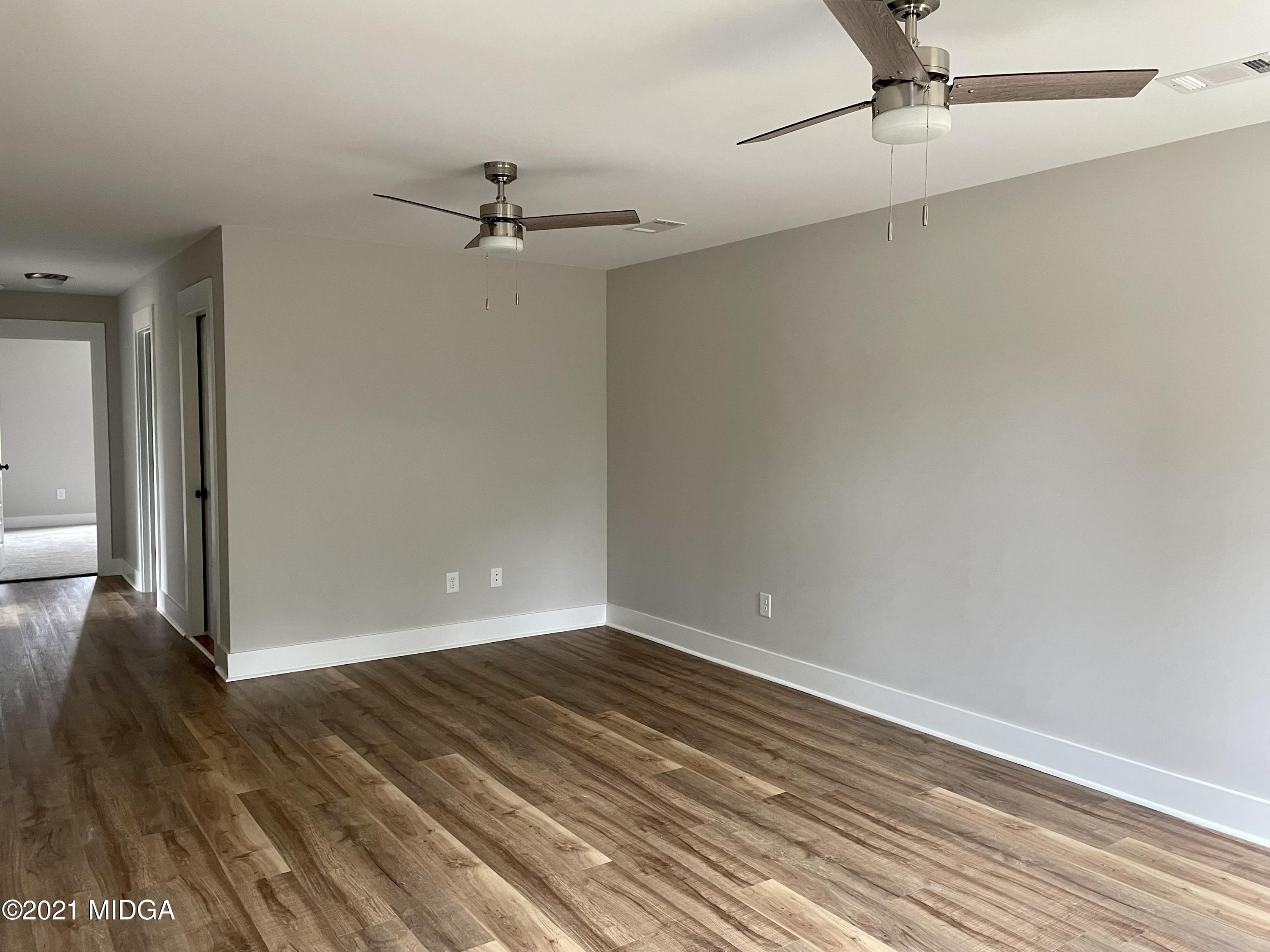 1194 Josey Road Forsyth, GA 31029 - Photo 2 of 9 wooden floor in an empty room