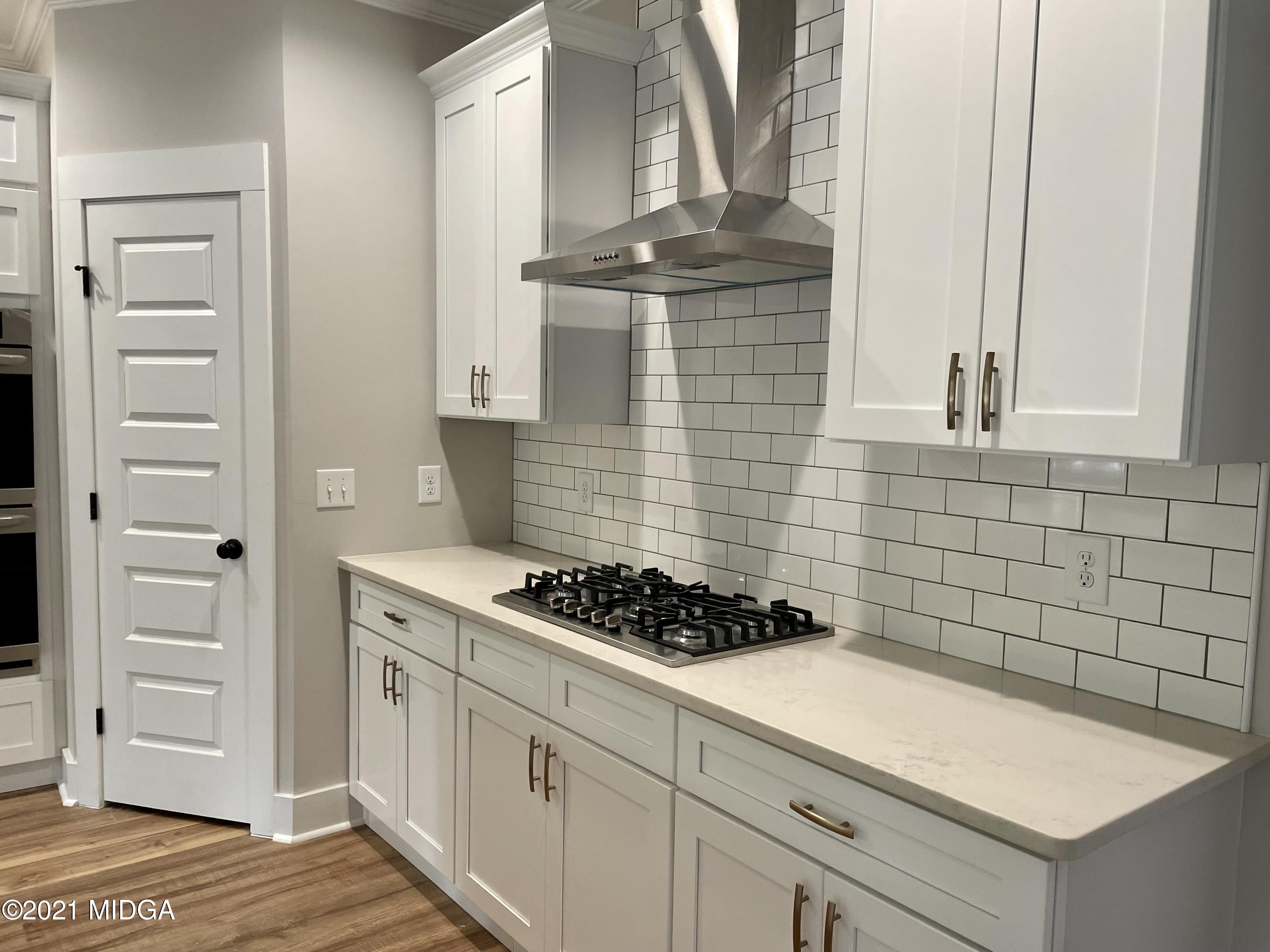 1194 Josey Road Forsyth, GA 31029 - Photo 3 of 9 a kitchen with a stove and cabinets