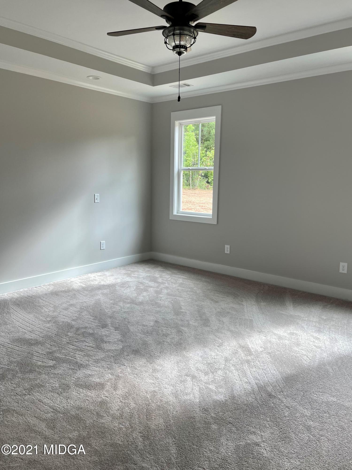 1194 Josey Road Forsyth, GA 31029 - Photo 6 of 9 an empty room with a ceiling fan and window