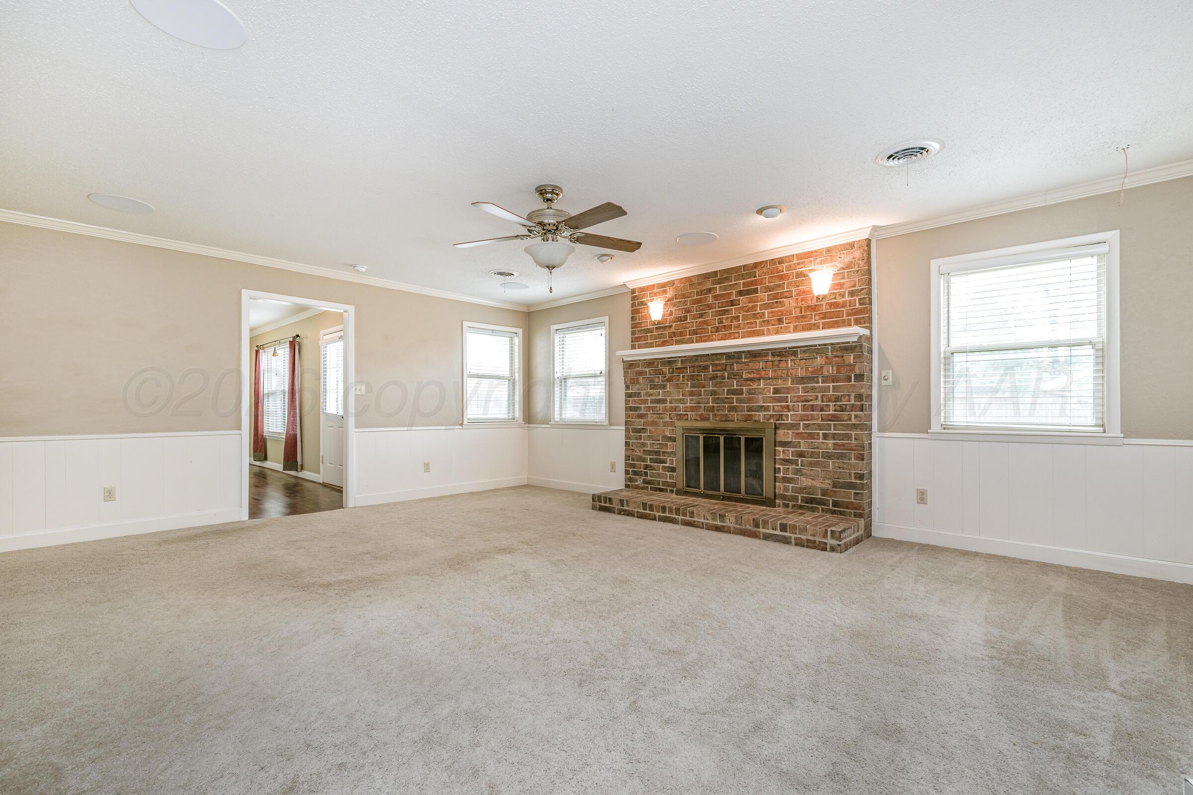 4400 West Farmers Avenue Amarillo, TX 79110 - Photo 7 of 27 an empty room with windows and fireplace