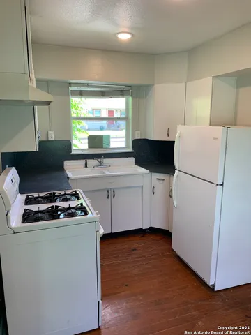 a kitchen with stainless steel appliances a refrigerator sink stove and cabinets