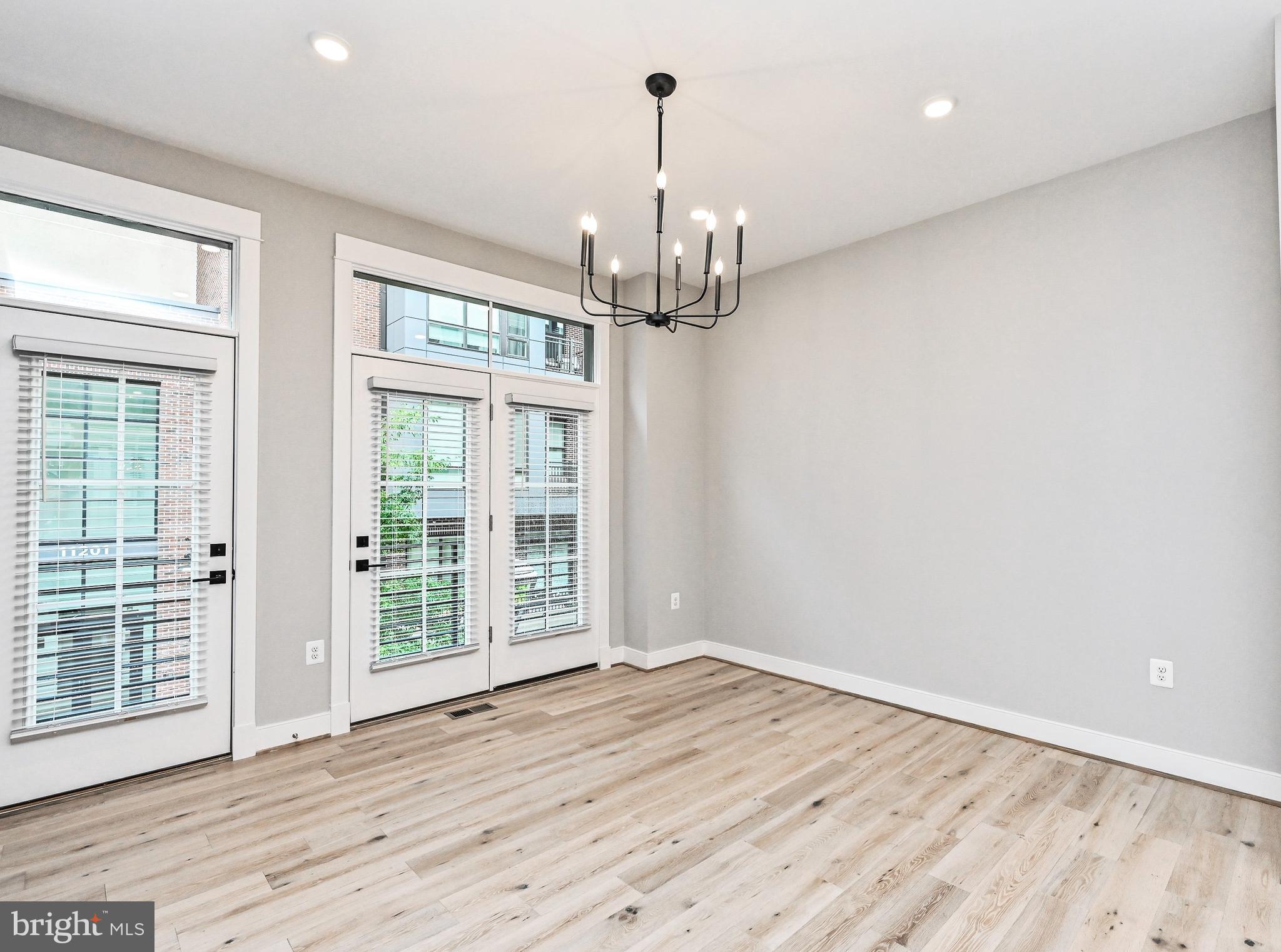 1892 Easterly Road Reston, VA 20190 - Photo 15 of 45 an empty room with wooden floor chandelier and windows