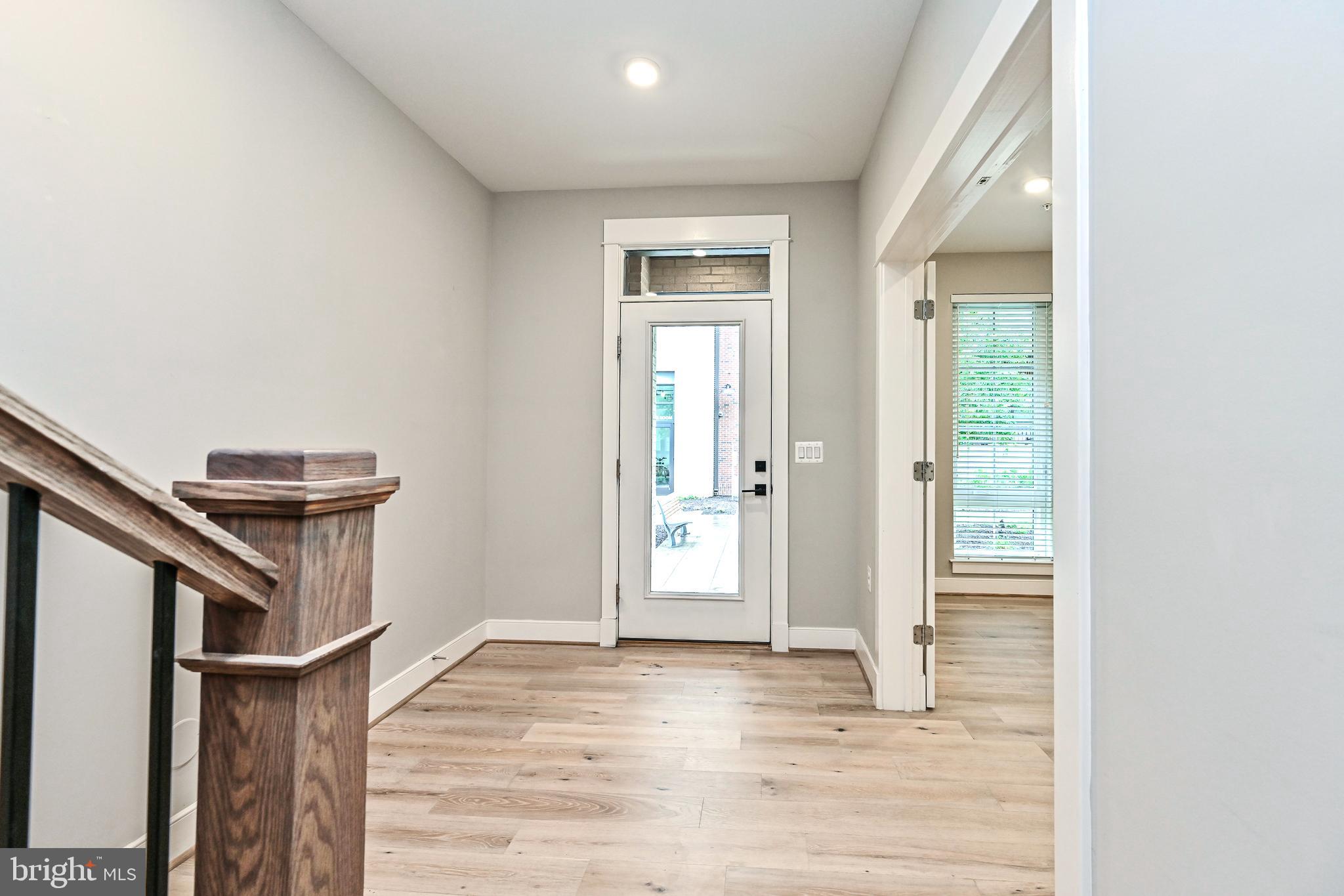 1892 Easterly Road Reston, VA 20190 - Photo 3 of 45 a view of an empty room with wooden floor and a window