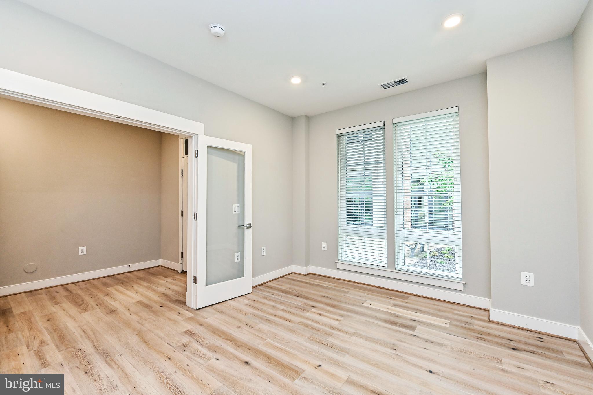 1892 Easterly Road Reston, VA 20190 - Photo 4 of 45 a view of an empty room with wooden floor and a window