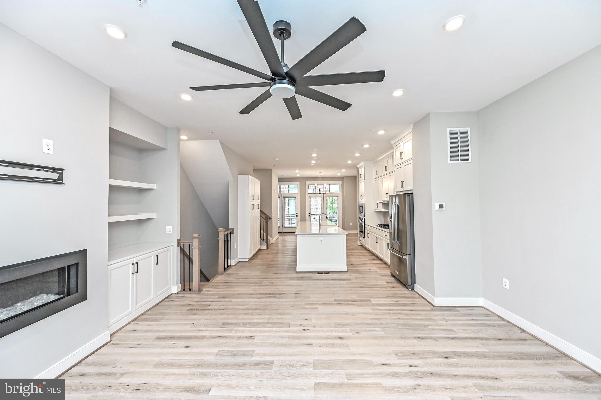 1892 Easterly Road Reston, VA 20190 - Photo 9 of 45 a large white kitchen with stainless steel appliances a large counter top a sink a refrigerator and a window