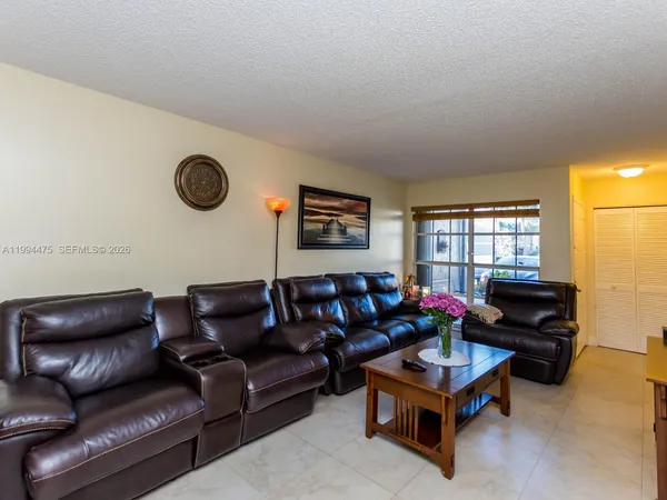 a living room with furniture a air conditioner and a window