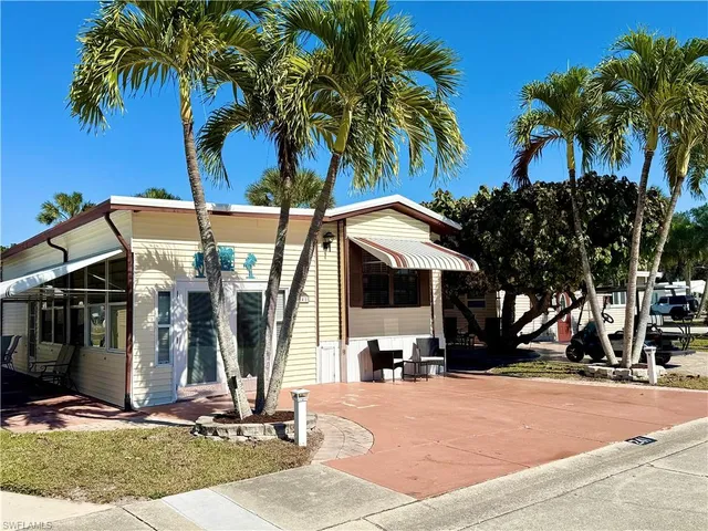 a view of a house with backyard and palm tree