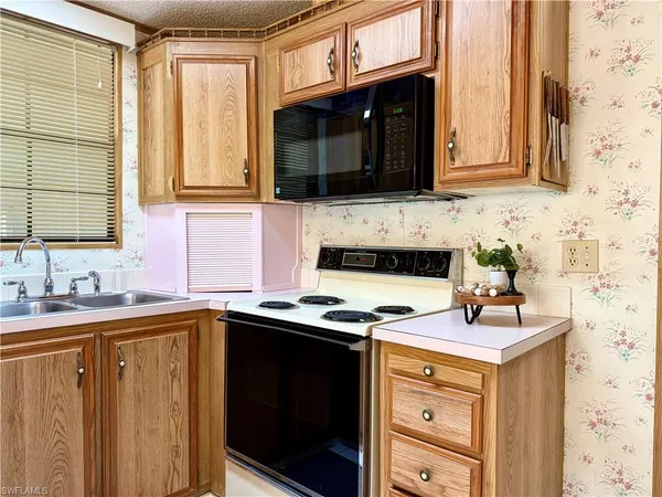 a kitchen with stainless steel appliances a sink stove and microwave