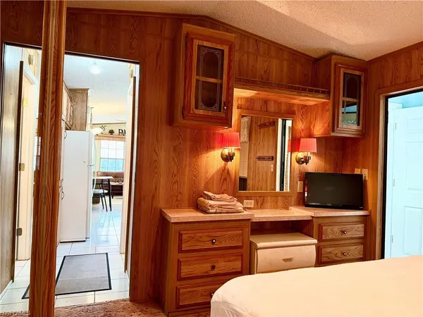 a bedroom with a bed and a flat tv screen