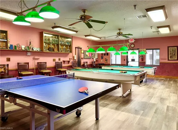 a living room with furniture and a pool table