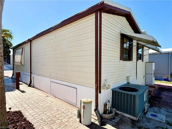 a view of a house with backyard and sitting area